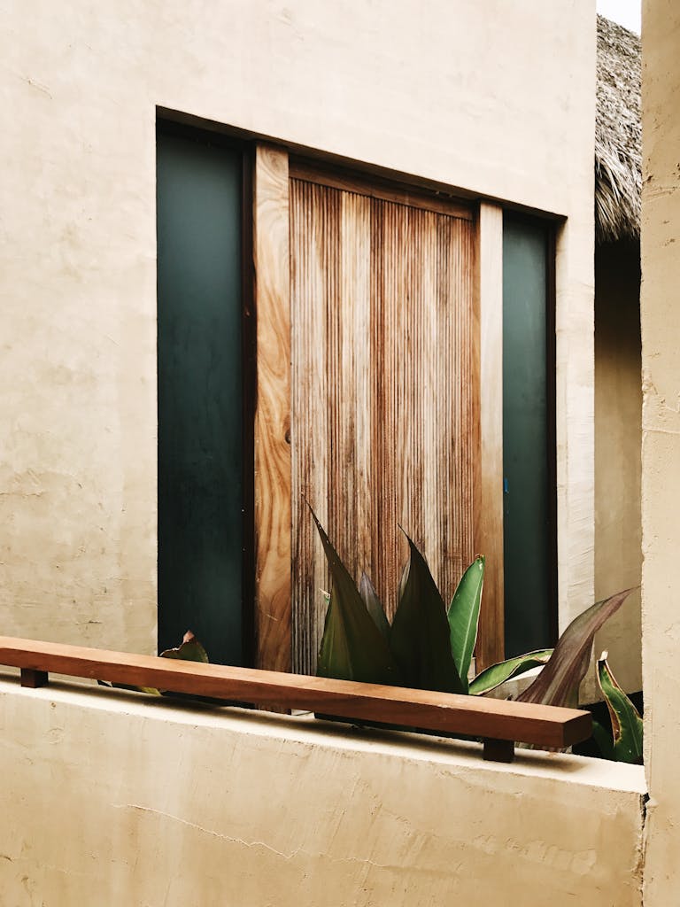 a rustic wooden doorway framed by plants capturing the essence of mexican architecture in sayulita. 29904629 768x1024.jpg
